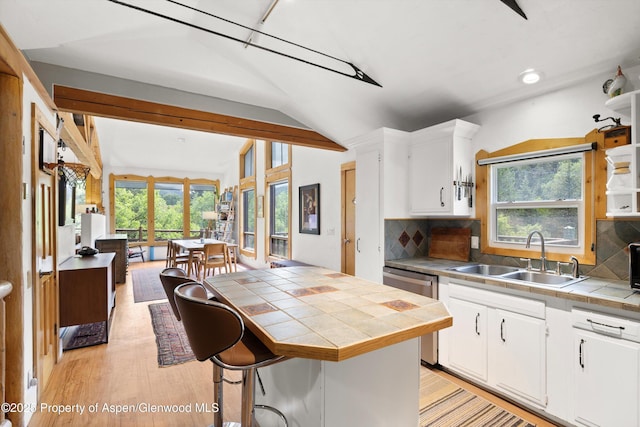 116 S Bill Creek Rd, Carbondale, CO 81623 - kitchen with tile countertops, vaulted ceiling, plenty of natural light, backsplash, and white cabinets