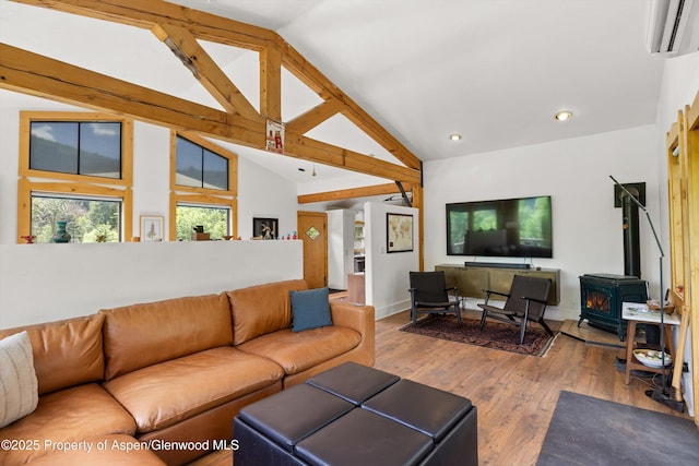 116 S Bill Creek Rd, Carbondale, CO 81623 - living room featuring an AC wall unit, vaulted ceiling, a wood stove, wood finished floors, and recessed lighting