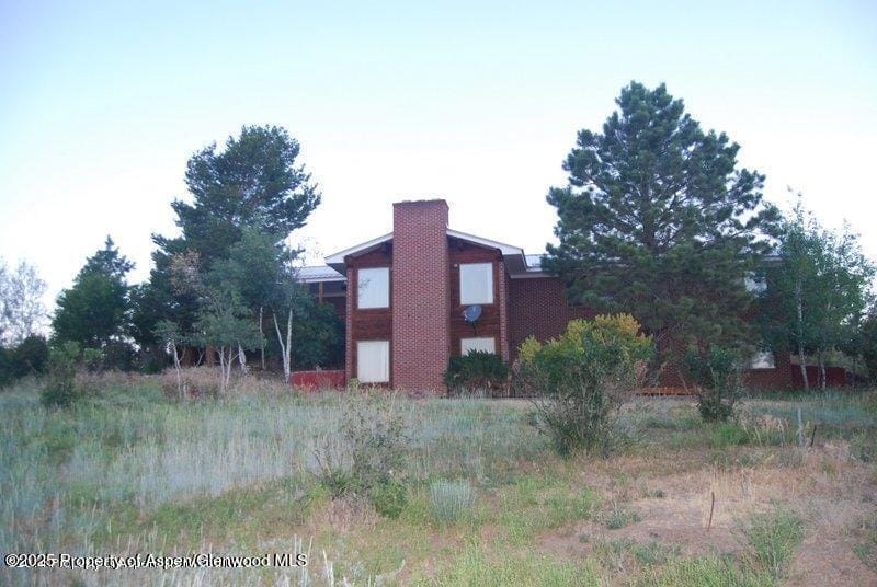 5712 County Road 29, Craig, CO 81625 - view of home's exterior featuring a chimney