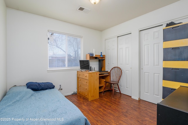 473 Robin Ct, Grand Junction, CO 81504 - bedroom with dark wood-style floors, an office area, and multiple closets