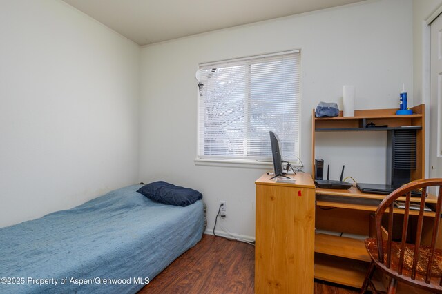 473 Robin Ct, Grand Junction, CO 81504 - bedroom with wood finished floors, multiple windows, and an office area