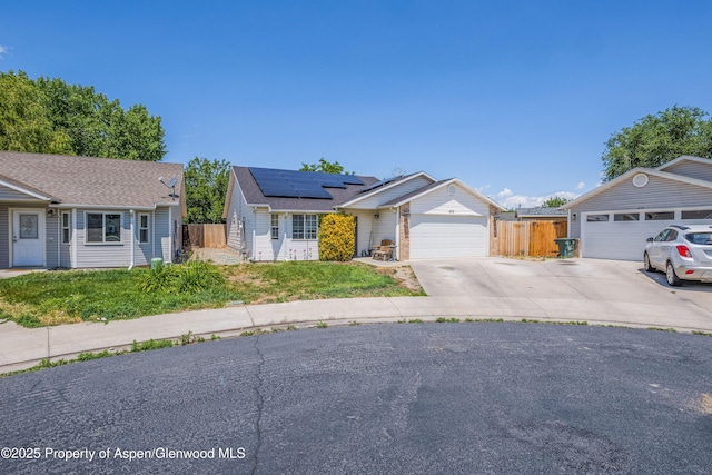 473 Robin Ct, Grand Junction, CO 81504 - ranch-style house featuring solar panels, driveway, and roof with shingles