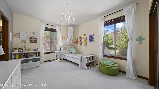 bedroom featuring multiple windows, a chandelier, and light carpet