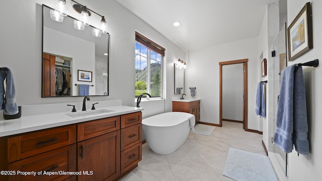 bathroom with vanity, a bath, and tile patterned flooring