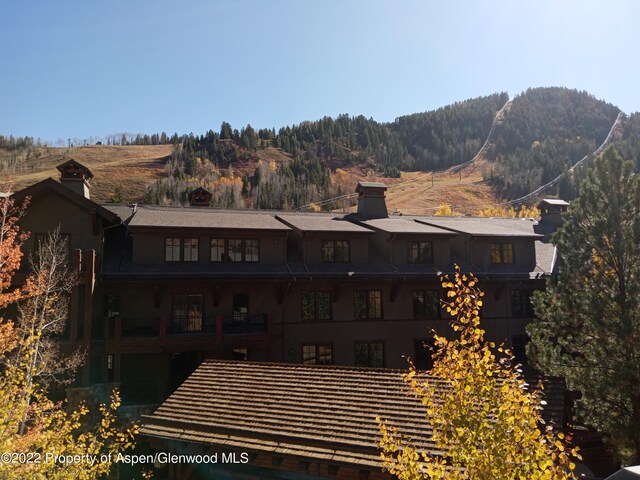 rear view of house featuring a mountain view