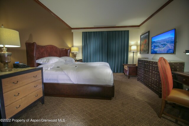 bedroom with dark carpet and ornamental molding