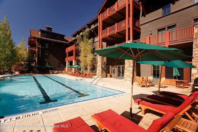 view of swimming pool with a patio