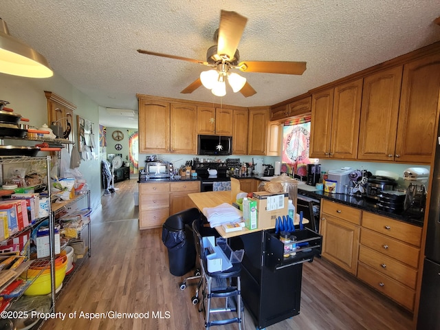 27461/2 Laguna Dr, Grand Junction, CO 81503 - kitchen with a ceiling fan, wood finished floors, brown cabinets, and black appliances