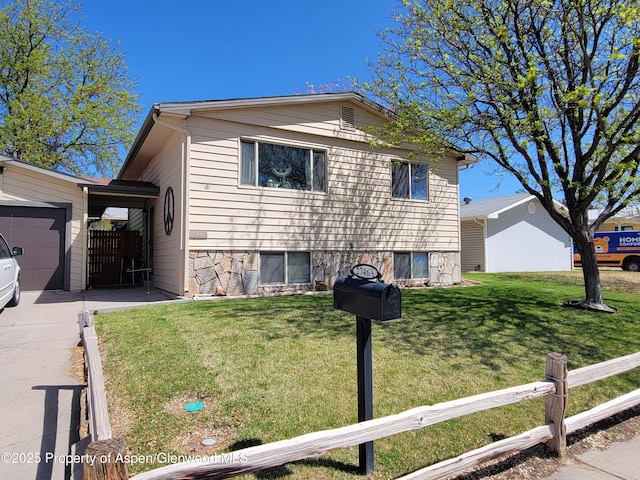27461/2 Laguna Dr, Grand Junction, CO 81503 - view of front of property with fence, an attached garage, a front lawn, and concrete driveway