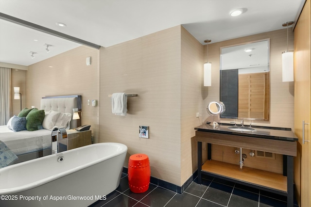 bathroom featuring tile patterned floors, a freestanding bath, and vanity