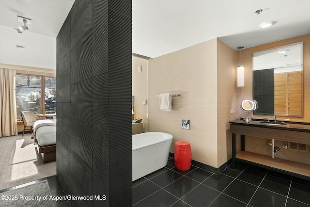 full bathroom featuring tile patterned floors, vanity, ensuite bathroom, and a freestanding tub