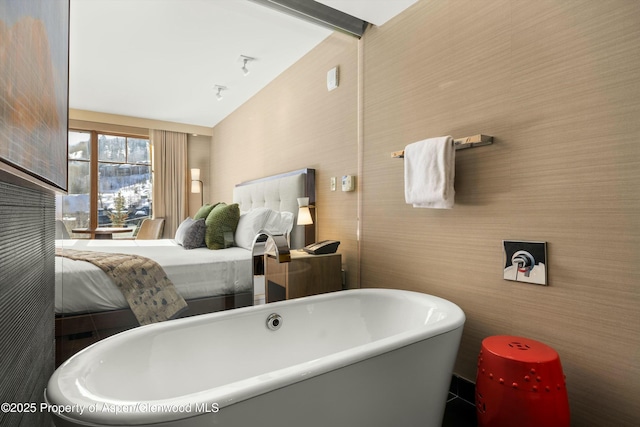 full bathroom with a freestanding bath and vaulted ceiling