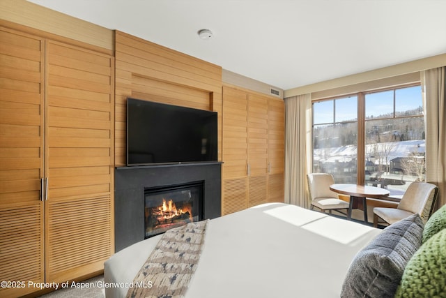 bedroom featuring visible vents and a large fireplace