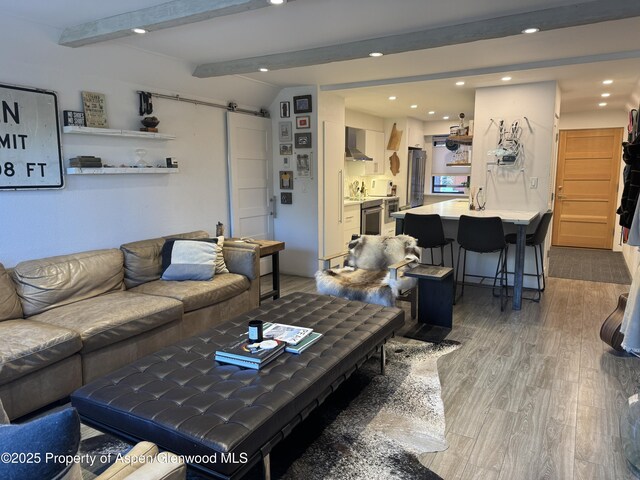 927 Vine St, Aspen, CO 81611 - living room with a barn door, beam ceiling, recessed lighting, and wood finished floors