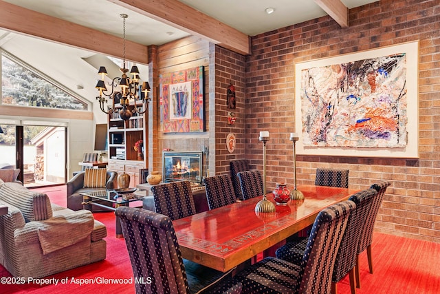 625 S W End St Unit 12, Aspen, CO 81611 - dining area with beam ceiling, a chandelier, wood finished floors, a glass covered fireplace, and brick wall