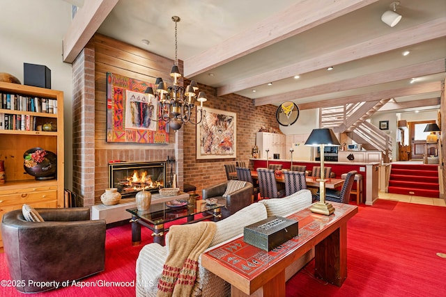 625 S W End St Unit 12, Aspen, CO 81611 - living room with stairs, a brick fireplace, brick wall, beamed ceiling, and wood finished floors