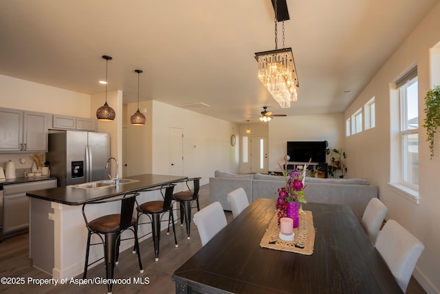 1149 E 17th St, Rifle, CO 81650 - dining space featuring a chandelier, dark wood-style flooring, and a ceiling fan