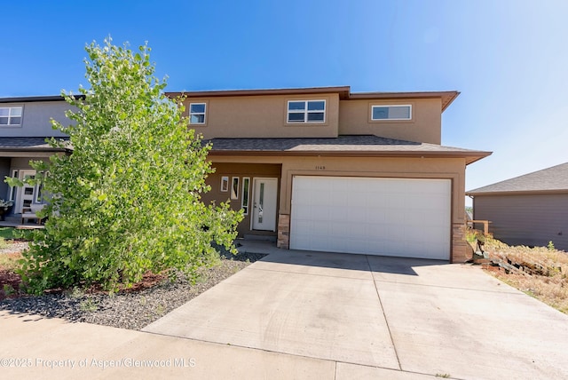 1149 E 17th St, Rifle, CO 81650 - view of front of house featuring stucco siding, an attached garage, and driveway