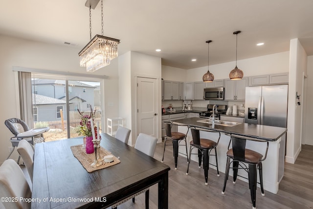 1149 E 17th St, Rifle, CO 81650 - dining area with light wood-type flooring, recessed lighting, and a chandelier