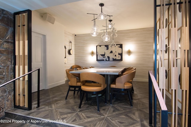 dining area featuring dark parquet flooring