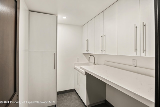 kitchen featuring white cabinets and sink