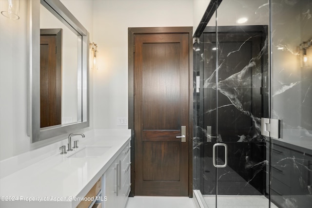 bathroom featuring vanity and a shower with shower door