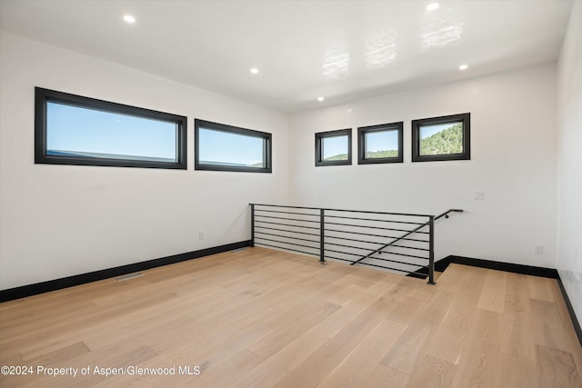 unfurnished room with light wood-type flooring