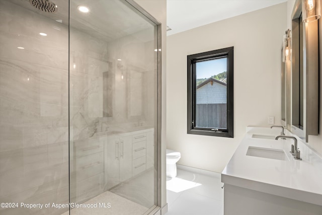 bathroom featuring tile patterned flooring, vanity, an enclosed shower, and toilet