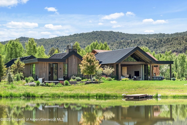 33 St Finnbar Farm Rd, Carbondale, CO 81623 - rear view of property with a forest view, a metal roof, a chimney, and a water and mountain view