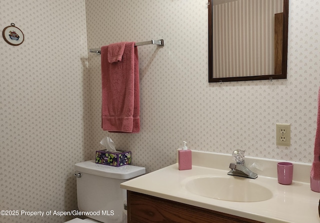 936 Legion St, Craig, CO 81625 - bathroom featuring vanity, toilet, and wallpapered walls