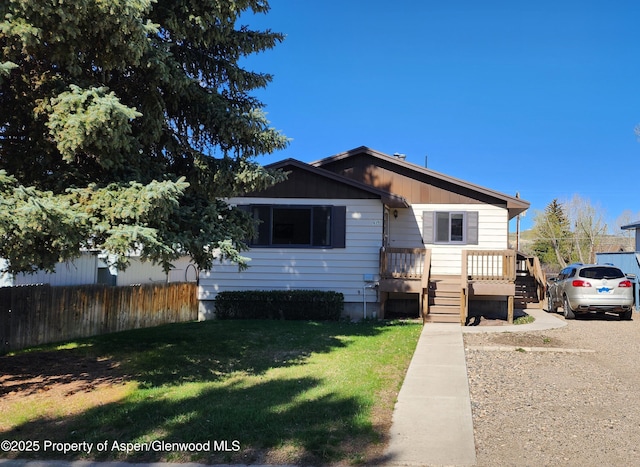 936 Legion St, Craig, CO 81625 - bungalow with a front lawn, board and batten siding, and fence