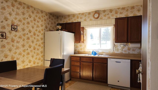 936 Legion St, Craig, CO 81625 - kitchen featuring white appliances, wallpapered walls, a sink, and light countertops