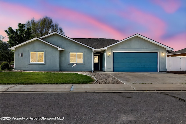 165 Harris Ln, Parachute, CO 81635 - single story home with an attached garage, concrete driveway, and stucco siding
