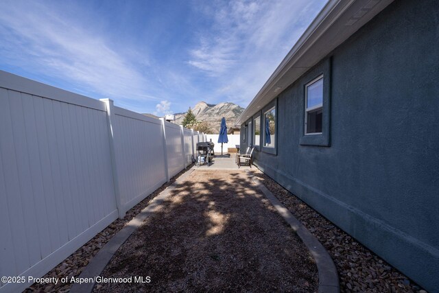 165 Harris Ln, Parachute, CO 81635 - fenced backyard featuring a patio and a mountain view
