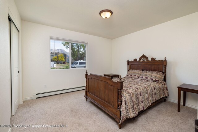 165 Harris Ln, Parachute, CO 81635 - bedroom with baseboard heating, light colored carpet, and a closet
