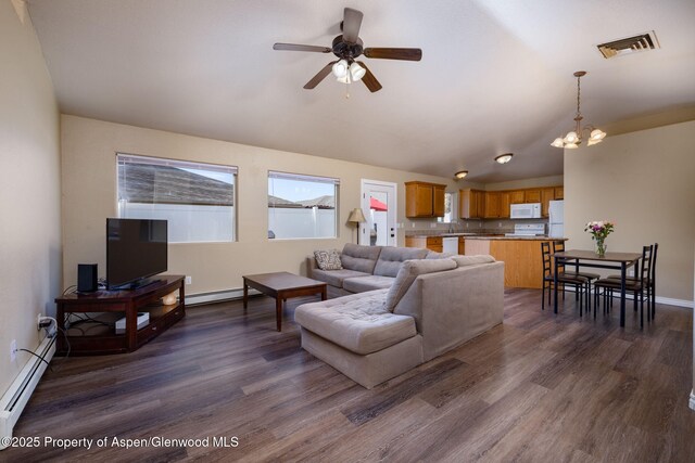 165 Harris Ln, Parachute, CO 81635 - living room featuring a baseboard heating unit, baseboard heating, dark wood-style floors, a ceiling fan, and vaulted ceiling