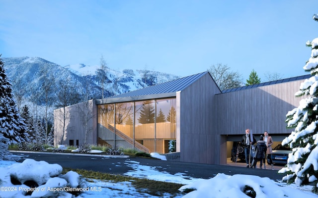 view of snow covered exterior with a mountain view