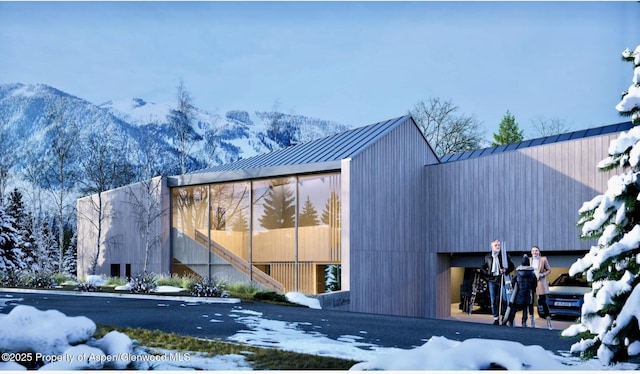 1212 E Hopkins Ave, Aspen, CO 81611 - view of snow covered exterior with a metal roof, a mountain view, and a standing seam roof