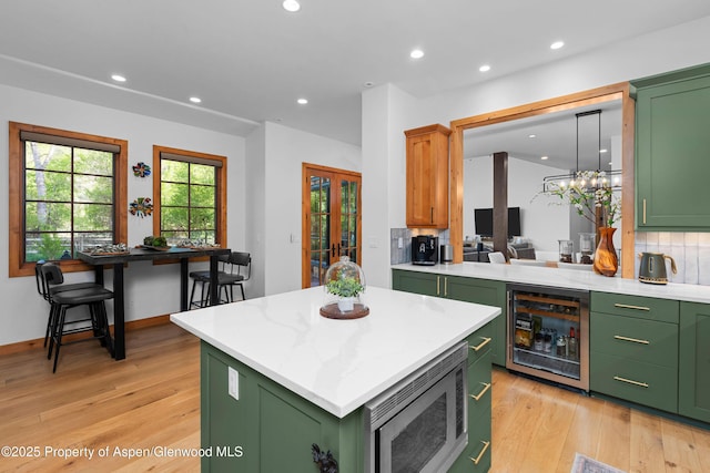236 Bristlecone Dr, Carbondale, CO 81623 - kitchen with green cabinetry, wine cooler, stainless steel microwave, and recessed lighting