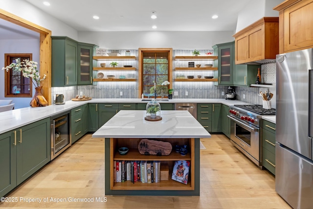 236 Bristlecone Dr, Carbondale, CO 81623 - kitchen featuring open shelves, green cabinets, stainless steel appliances, beverage cooler, and tasteful backsplash