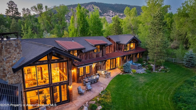 236 Bristlecone Dr, Carbondale, CO 81623 - back of house featuring a patio area, an outdoor living space, a chimney, a view of trees, and a mountain view