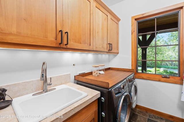 236 Bristlecone Dr, Carbondale, CO 81623 - laundry area featuring cabinet space, washer and dryer, dark stone finish floors, and baseboards