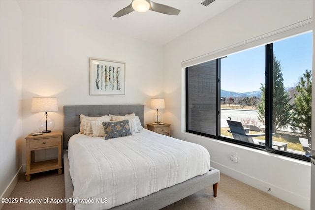 bedroom featuring carpet flooring, visible vents, baseboards, and ceiling fan