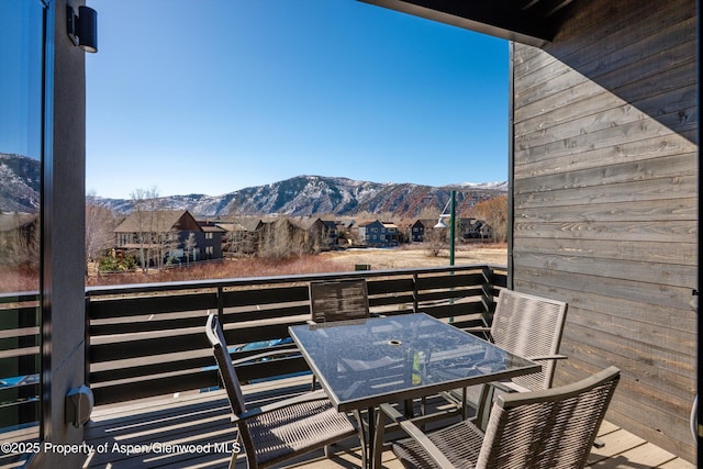 exterior space with outdoor dining area, a mountain view, a residential view, and a balcony