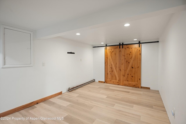 341 Park Dr, Glenwood Springs, CO 81601 - unfurnished room with light wood-style floors, a barn door, a baseboard heating unit, and recessed lighting