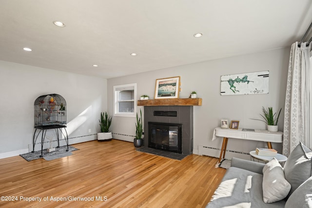 341 Park Dr, Glenwood Springs, CO 81601 - living room featuring recessed lighting, light wood-type flooring, a tile fireplace, a baseboard radiator, and baseboard heating