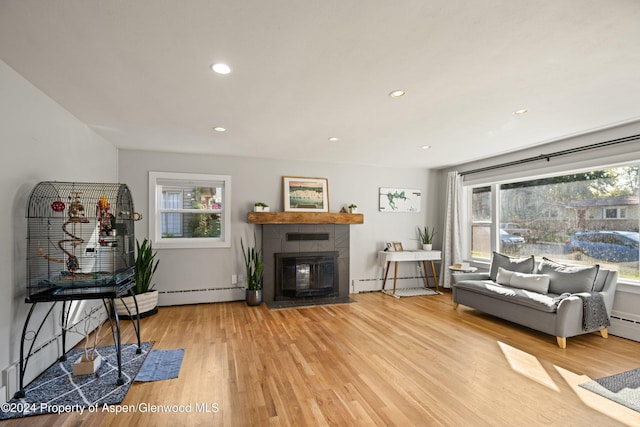 341 Park Dr, Glenwood Springs, CO 81601 - living area with wood finished floors, a tile fireplace, recessed lighting, and baseboard heating