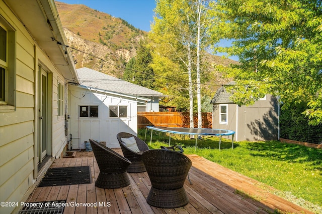 341 Park Dr, Glenwood Springs, CO 81601 - wooden deck with a mountain view, a shed, and a trampoline