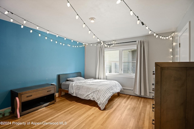 341 Park Dr, Glenwood Springs, CO 81601 - bedroom with wood finished floors and baseboard heating