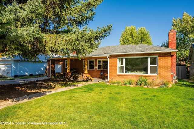 341 Park Dr, Glenwood Springs, CO 81601 - view of front of property featuring brick siding, a chimney, a front yard, and a shingled roof